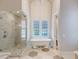 Elegant bathroom with freestanding tub, walk-in shower, and marble tile at 3703 Hartnett Blvd, Isle of Palms, SC 29451