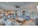 Open living room with light blue sofas, a rustic coffee table and hardwood floors at 3703 Hartnett Blvd, Isle of Palms, SC 29451