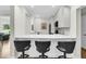Modern kitchen with white cabinets, quartz countertop, and breakfast bar at 4910 Green Dolphin Way, Kiawah Island, SC 29455