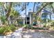 Two-story home with gray siding, blue accents, and landscaping at 4910 Green Dolphin Way, Kiawah Island, SC 29455