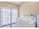 Laundry room with white washer and dryer and french doors at 1090 Peru Rd, Saint Stephen, SC 29479