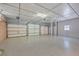 Spacious three-car garage with epoxy flooring and ample overhead storage at 1090 Peru Rd, Saint Stephen, SC 29479