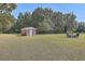 Brick shed in a large backyard with a fire pit and seating area at 1090 Peru Rd, Saint Stephen, SC 29479
