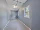 Empty storage room with gray walls and flooring, featuring two windows at 1090 Peru Rd, Saint Stephen, SC 29479