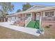 Brick ranch house with attached garage and green carpeted steps leading to the porch at 1090 Peru Rd, Saint Stephen, SC 29479