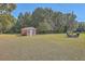 Brick shed in a large backyard with a fire pit and seating area at 1090 Peru Rd, Saint Stephen, SC 29479
