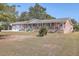 Brick ranch house with attached garage, covered porch, and American flag at 1090 Peru Rd, Saint Stephen, SC 29479