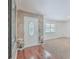 Bright entryway with hardwood floors, stone wall, and white door at 1090 Peru Rd, Saint Stephen, SC 29479