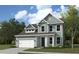 Two-story house with a green exterior and a white garage door at 4 Wappoo Trace Ln, Summerville, SC 29486
