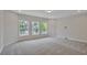 Bright bedroom with three windows and wall-to-wall carpet at 13 Tidewater Ln, Summerville, SC 29486