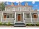 Two story home with front porch and red roof at 59 Ashe St, Charleston, SC 29403
