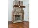 Rustic exposed brick fireplace with a reclaimed wood mantel at 59 Ashe St, Charleston, SC 29403