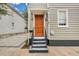 Welcoming entrance with a rich orange door and black railing at 59 Ashe St, Charleston, SC 29403