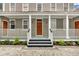 Front porch with white railings and a charming entrance at 59 Ashe St, Charleston, SC 29403
