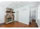 Spacious bedroom with hardwood floors, exposed brick fireplace, and updated window treatments at 59 Ashe St, Charleston, SC 29403