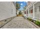 Cobblestone driveway with landscaping, leading to charming home at 59 Ashe St, Charleston, SC 29403