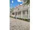 Two-story home with a large front porch and brick driveway at 59 Ashe St, Charleston, SC 29403