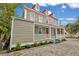 Two story renovated home with red roof and white porch at 59 Ashe St, Charleston, SC 29403