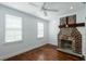 Charming bedroom with hardwood floors, exposed brick fireplace, and updated window treatments at 59 Ashe St, Charleston, SC 29403