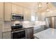 Modern kitchen with stainless steel appliances and white subway tile backsplash at 59 Ashe St, Charleston, SC 29403