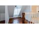 Bright upper hallway with hardwood floors and white painted walls at 59 Ashe St, Charleston, SC 29403