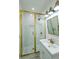 Bathroom with white subway tiles, brass fixtures, and glass shower at 59 Ashe St, Charleston, SC 29403