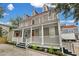 Two story home with front porch and red roof at 59 Ashe St, Charleston, SC 29403