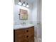 Elegant bathroom featuring a white quartz vanity, brass fixtures, and hexagon tile flooring at 59 Ashe St, Charleston, SC 29403