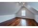 Bright attic bedroom with wood floors and window at 59 Ashe St, Charleston, SC 29403