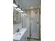 Modern bathroom with white subway tiles, brass fixtures, and a glass shower enclosure at 59 Ashe St, Charleston, SC 29403