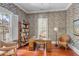 Home office with floral wallpaper, built-in bookcase, and hardwood floors at 106 W Shipyard Rd, Mount Pleasant, SC 29464