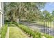 Landscaped front yard with lush greenery and wrought iron fence at 106 W Shipyard Rd, Mount Pleasant, SC 29464