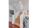 Elegant staircase with white railings and a natural fiber runner at 106 W Shipyard Rd, Mount Pleasant, SC 29464