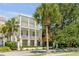 Two-story house with white exterior, balconies, and palm trees at 106 W Shipyard Rd, Mount Pleasant, SC 29464
