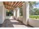 Spacious front porch with tile flooring, white columns, and wood beam ceiling at 106 W Shipyard Rd, Mount Pleasant, SC 29464