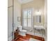 Stylish bathroom with white sink, toilet, and shower, plus hardwood floors at 106 W Shipyard Rd, Mount Pleasant, SC 29464