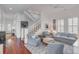 Light-filled living room with hardwood floors, comfortable seating, and a view of the staircase at 106 W Shipyard Rd, Mount Pleasant, SC 29464