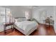 Bedroom with hardwood floors, a queen bed, and a writing desk at 106 W Shipyard Rd, Mount Pleasant, SC 29464