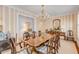 Elegant dining room with hardwood floors, striped wallpaper, and a large wooden table at 106 W Shipyard Rd, Mount Pleasant, SC 29464