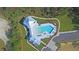 Aerial view of community pool and clubhouse with surrounding landscape at Lot 93 Lady Banks Ln, Hollywood, SC 29470