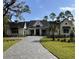White farmhouse with black accents, a paved driveway, and lush landscaping at Lot 93 Lady Banks Ln, Hollywood, SC 29470