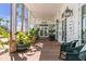 Relaxing front porch with rocking chairs and tropical plants at 9844 Haven Loop, Johns Island, SC 29455