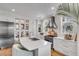 White kitchen with stainless steel appliances and large island with seating at 9844 Haven Loop, Johns Island, SC 29455