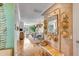 Bright entryway with hardwood floors, decorative wall, and view into living area at 9844 Haven Loop, Johns Island, SC 29455