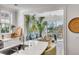 Kitchen with island seating overlooking sunroom with water views at 9844 Haven Loop, Johns Island, SC 29455