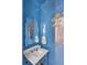 Chic powder room with blue walls and palm tree art at 9844 Haven Loop, Johns Island, SC 29455