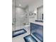 Modern bathroom with navy vanity and marble shower at 9844 Haven Loop, Johns Island, SC 29455