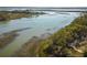 Aerial view of serene marsh with boat and dock at 9844 Haven Loop, Johns Island, SC 29455