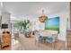 Open living room with hardwood floors, stylish seating, and large artwork at 9844 Haven Loop, Johns Island, SC 29455