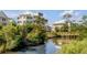 Wooden boardwalk over calm water with lush green vegetation at 9844 Haven Loop, Johns Island, SC 29455
